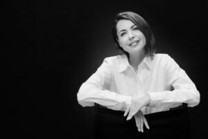 Naine mustal taustal valges särgis